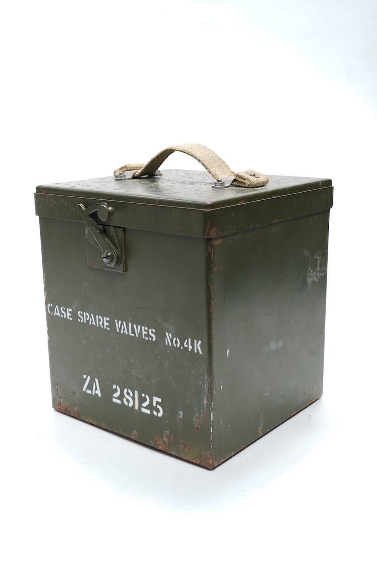 A collection of primarily 20th century military badges, lapel badges, shoulder titles, and other related ephemera, including seventeen military cap badges, cloth badges, ARP badges, etc., together with a military tin box